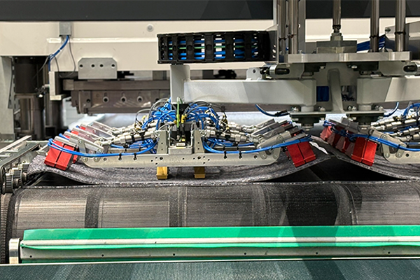 Needle gripper for self-adhesive carpet tiles