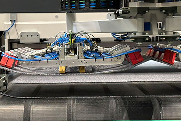 Needle gripper for self-adhesive carpet tiles