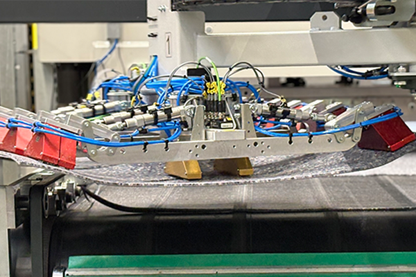 Needle gripper for self-adhesive carpet tiles